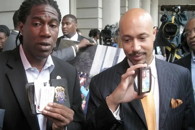 Jumaane Williams and Kirsten John Foy display the official IDs they showed cops before their arrest.